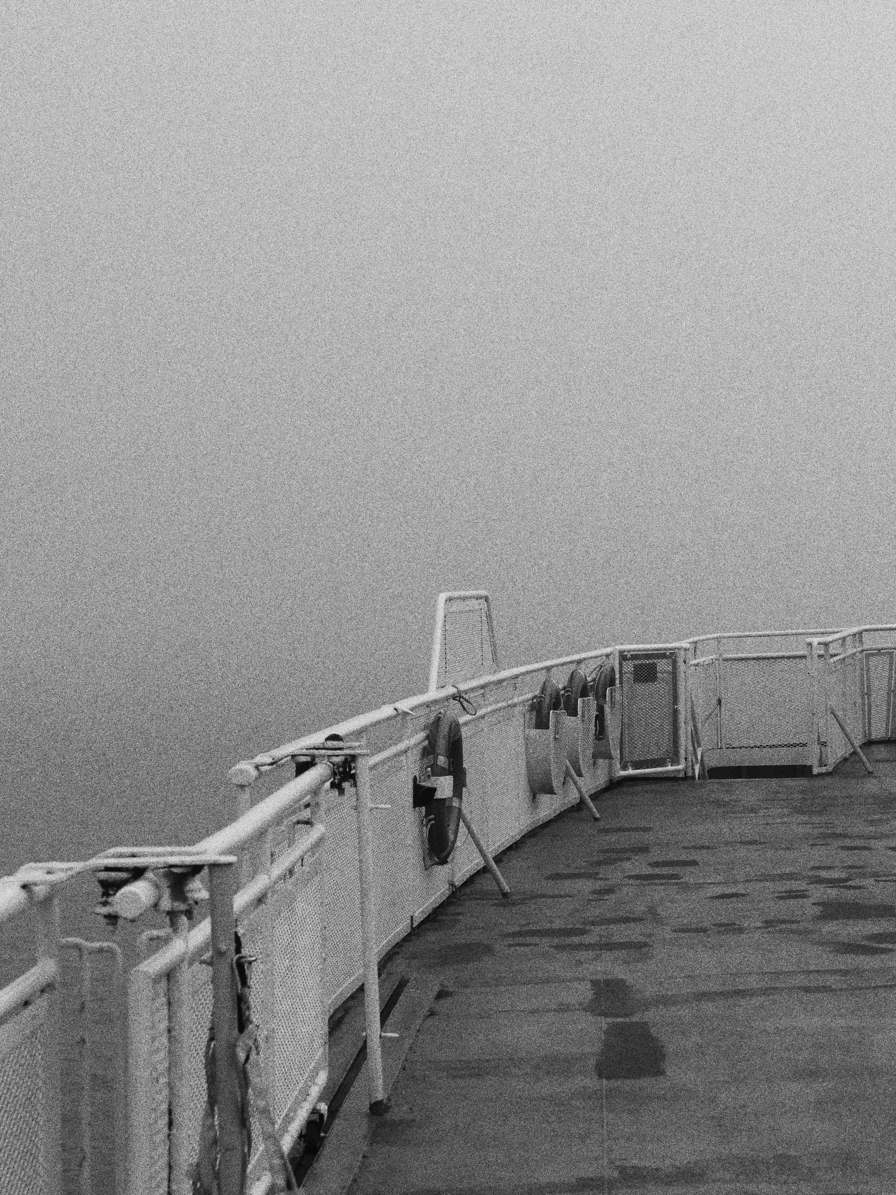 Black and white: the deck of a ferry in fog, photo by Byron Lambert