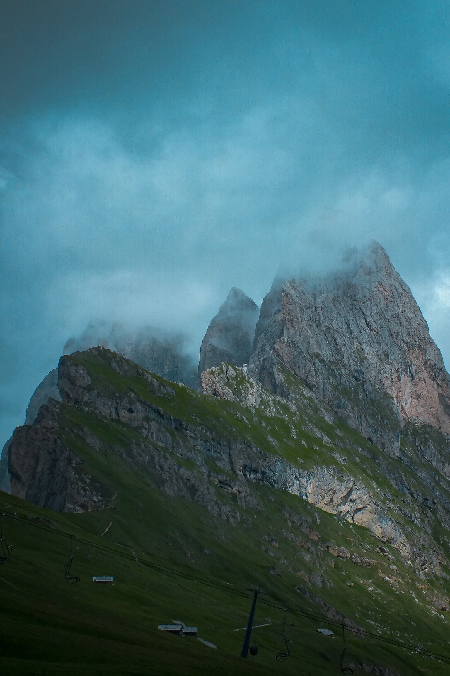 Jagged peaks in cloud above a chairlift, photo by Byron Lambert